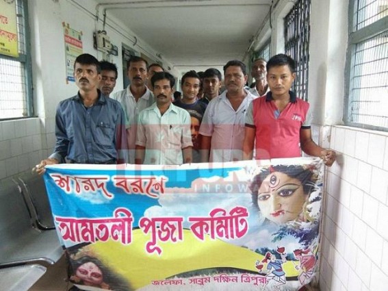 Amtali Puja committee distributes sweets and fruits on the eve of Maha Nabami at Sabroom hospital