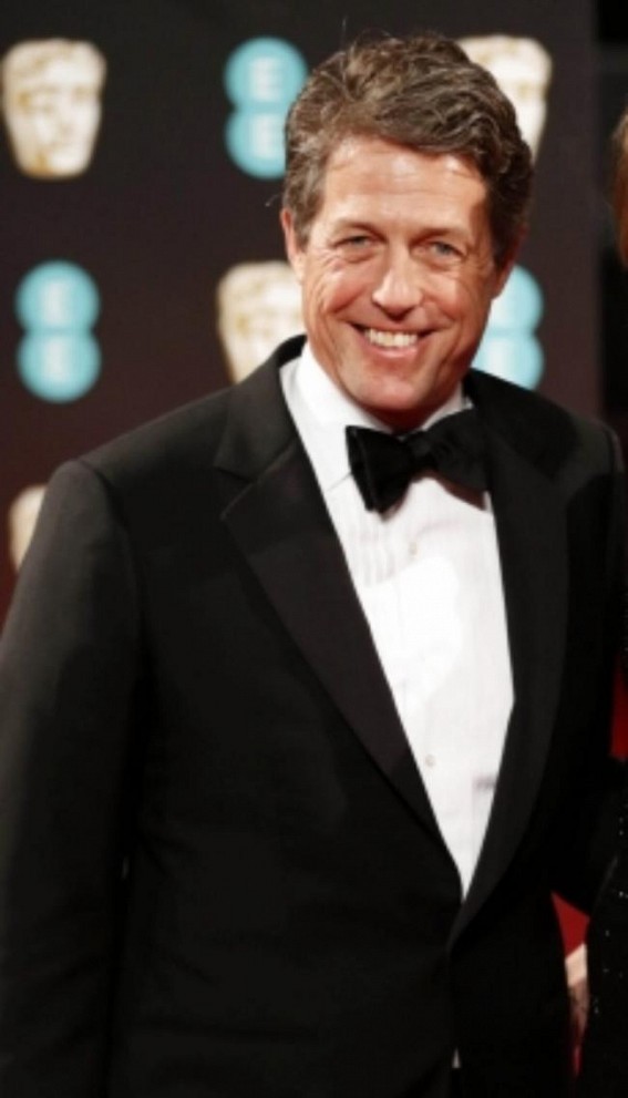 Hugh Grant 'trying to be a young father in an old man's body' at 60