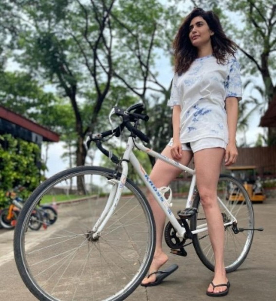Karishma strikes a pose with her bike