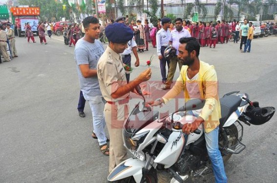 Agartala cops follow Gandhigiri to convince bikers to wear helmets Agartala cops follow Gandhigiri to convince bikers to wear helmets